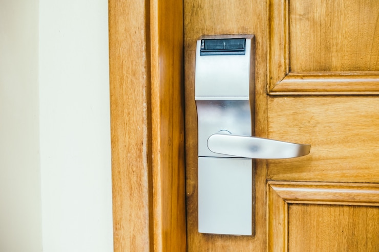 an electronic keyless door lock on a brown wooden door