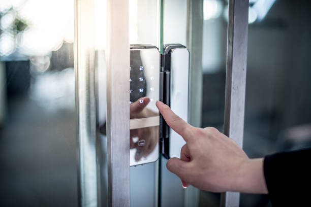 businessman hand pressing down password number on a keyless door lock