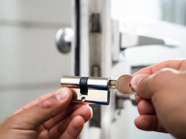 locksmith looking at a cabinet lock